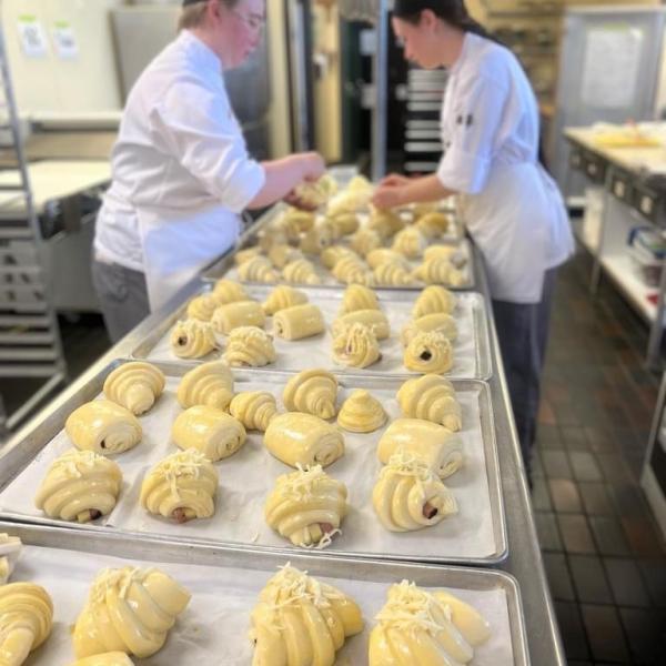 baking students working at trays of croissants